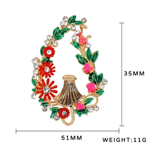 Vintage gold-plated flower basket brooch with red enamel blossoms and white rhinestones