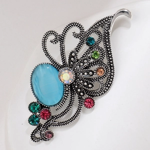 Detailed macro shot of vintage silver butterfly brooch with aurora purple and blue gems