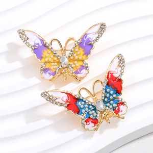 Broche papillon élégante avec ailes en émail coloré et cristaux blancs scintillants
