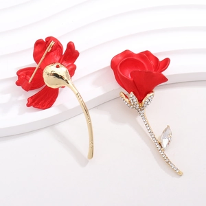 Macro shot of red rose brooch with golden stem, pearls and crystal details