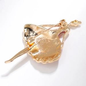 Detailed back view of golden ballerina brooch showing the secure pin and casting texture