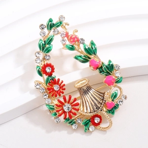 Elegant floral basket brooch with red enamel flowers and sparkling crystals on gold base