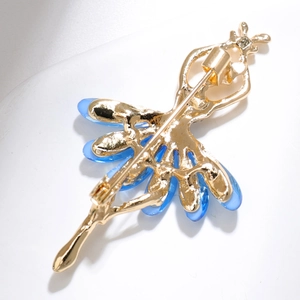 Detail view of the secure safety pin clasp on the gold ballerina dancer brooch