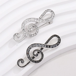 Elegant treble clef brooch set in silver and gun-black metal with sparkling rhinestones