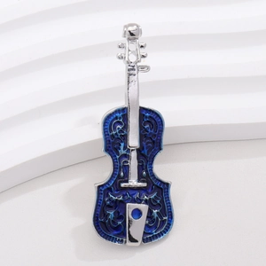 Detailed close-up of a silver violin brooch with blue enamel and hollow filigree design