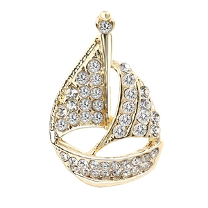 Elegant gold metal sailboat brooch featuring clear rhinestones in a minimalist design