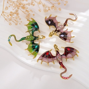 Detail of vintage dragon brooches with enamel finish and colorful crystal accents