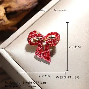 Vintage rote Strass-Schleifenbrosche mit Goldbasis misst 2,0x2,0 cm und wiegt 3 g