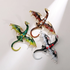 Detailed close-up of dragon pins with colorful enamel finish and sparkling rhinestones