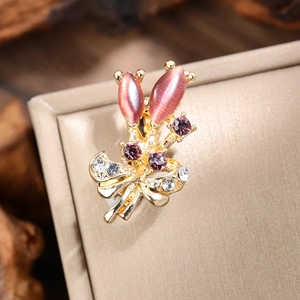 Macro shot of tulip brooch featuring pink cat-eye stones and sparkling crystal accents
