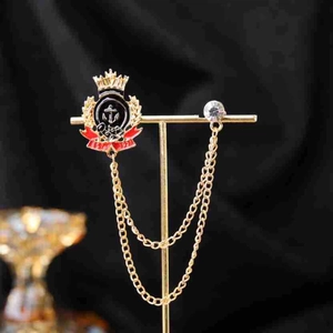 Vintage gold heraldic brooch with crown emblem, anchor, red ribbon and twin tassels