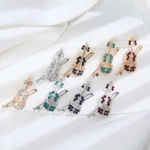 Detailed view of luxury violin brooches set with sparkling colorful rhinestones