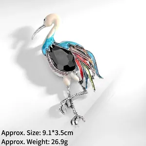 Detailed macro view of a vintage crane brooch with colorful enamel and black gemstone