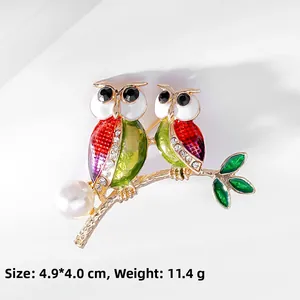 Detailed macro view of retro owl brooch with enamel, crystals and pearls showing 4.9*4.0cm size
