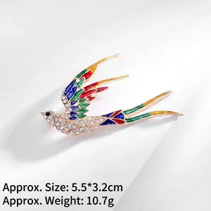 Exquisite bird brooch with colorful enamel wings and rhinestones in a golden finish