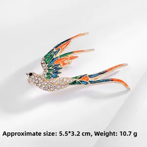 Detailed close-up of a vintage swallow bird brooch with colorful enamel and crystals