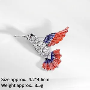 Elegant silver hummingbird brooch with crystals and blue gradient enamel finish
