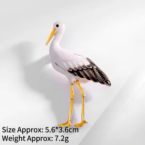 Detail of elegant white crane brooch with dimensions of 5.6x3.6cm and gold-tone finish