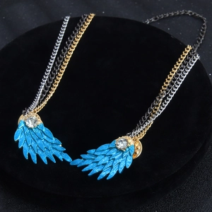 Blue enamel wing brooch with rhinestone accents and triple metallic layered chains