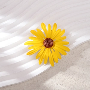 Detail of sunflower brooch with layered yellow petals and textured brown center