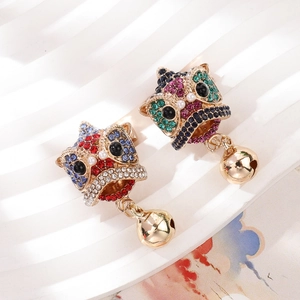 Detailed macro view of Chinese guardian lion brooches with colorful rhinestones and gold bells