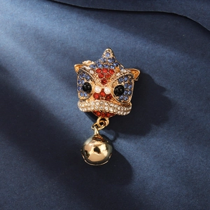 Chinese style lion dance brooch with colorful rhinestones and gold bell on blue fabric