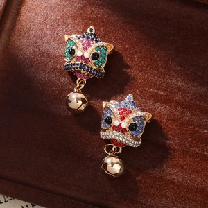 Detailed close-up of Chinese lion dance pins with colorful rhinestones and gold bells