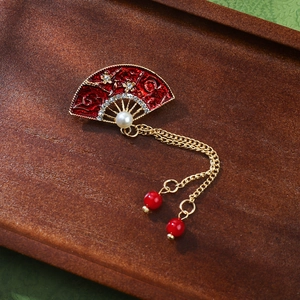 Elegant vintage fan brooch with red enamel, pearls and golden tassels for traditional dress