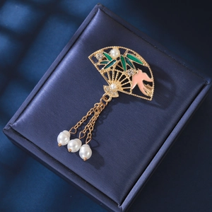 Detail of fan-shaped brooch with bamboo enamel, bird motif, and pearl tassels