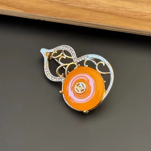 Vintage Chinese style hollow gourd brooch with orange stone and sparkling rhinestones