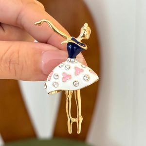 Elegant gold ballerina brooch with blue enamel and crystal-studded skirt in dancing pose