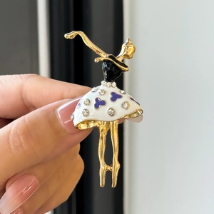 Close-up of ballet dancer brooch with blue floral enamel and sparkling rhinestones