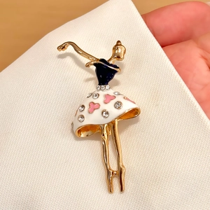 Close-up of ballet dancer brooch in gold alloy with blue enamel and crystal rhinestones