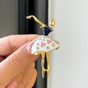Detailed view of a ballet dancer brooch featuring gold alloy and sparkling rhinestones