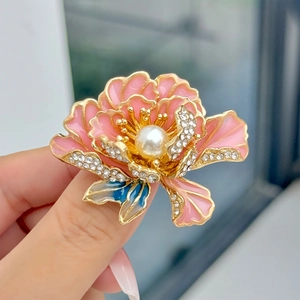 Detail van pioenroos broche met roze emaille bloemblaadjes, parel en kristallen bladeren