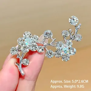 Macro view of crystal flower brooch with silver plating and radiant rhinestones
