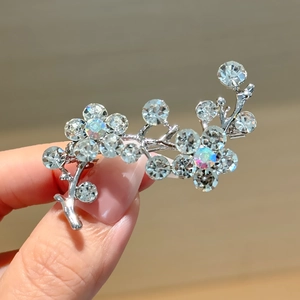 Elegant silver flower branch brooch with sparkling rhinestones and iridescent accent stones