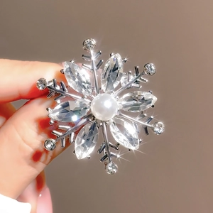 Elegant silver snowflake brooch with center pearl and sparkling rhinestone crystals