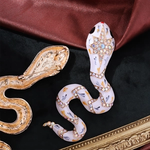 Vintage snake brooch in gold alloy with white enamel and colorful rhinestones