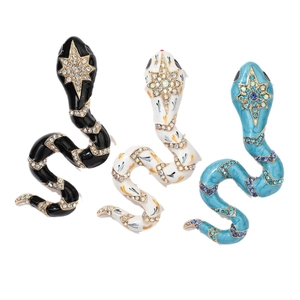 Vintage snake brooch set with enamel rhinestones in black, white, and teal colors