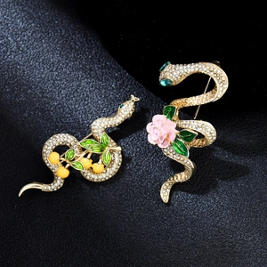 Elegant gold snake brooches with zircon crystals, pink flowers and green enamel leaves