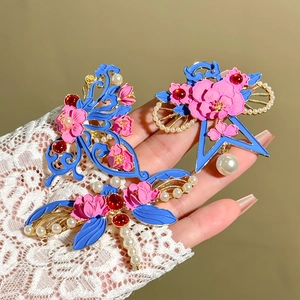 Detailed close-up of handmade enamel butterfly brooch with blue and pink pearls