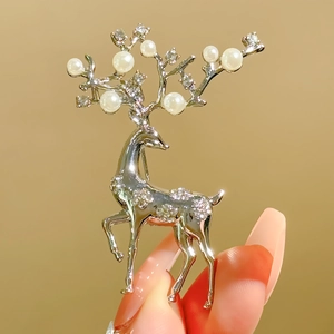 Broche élan argentée avec perles blanches et strass brillants pour manteaux chic