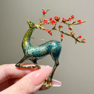 Vintage stag brooch with deer antler plum blossom branches and green enamel finish