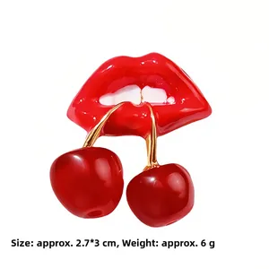 Detail of red lips biting cherry brooch with 2.7x3CM dimensions and gold enamel finish