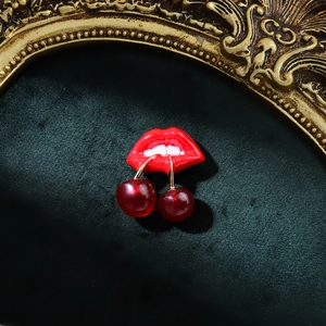 Artistic cherry and red lip brooch with glossy resin finish in vintage gold frame