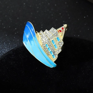 Luxury cruise ship brooch with blue enamel and sparkling crystals on gold metal base