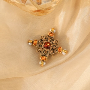 Vintage Baroque cross brooch with amber crystal and pearls on golden silk fabric