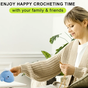 Detail of crochet kit showing a blue whale doll with yarn and tools in a cozy setting