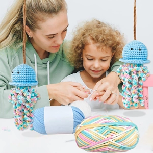 DIY crochet kit featuring blue yarn balls and handmade jellyfish keychains for crafts